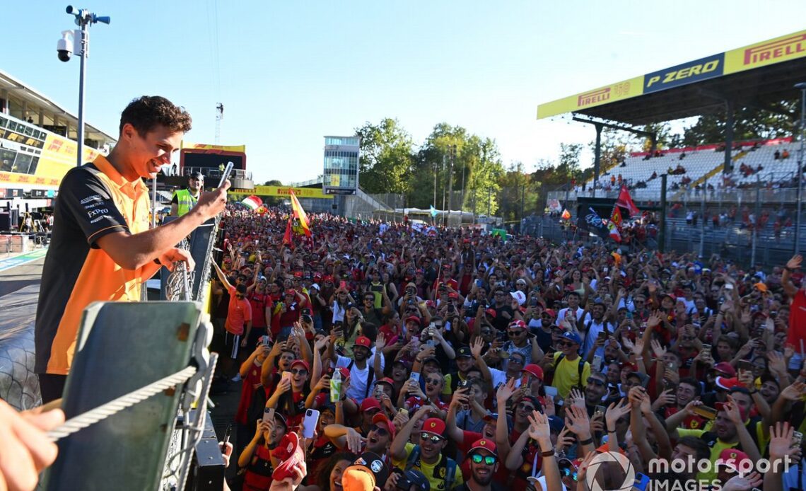 Lando Norris, McLaren, takes a photo of the crowds