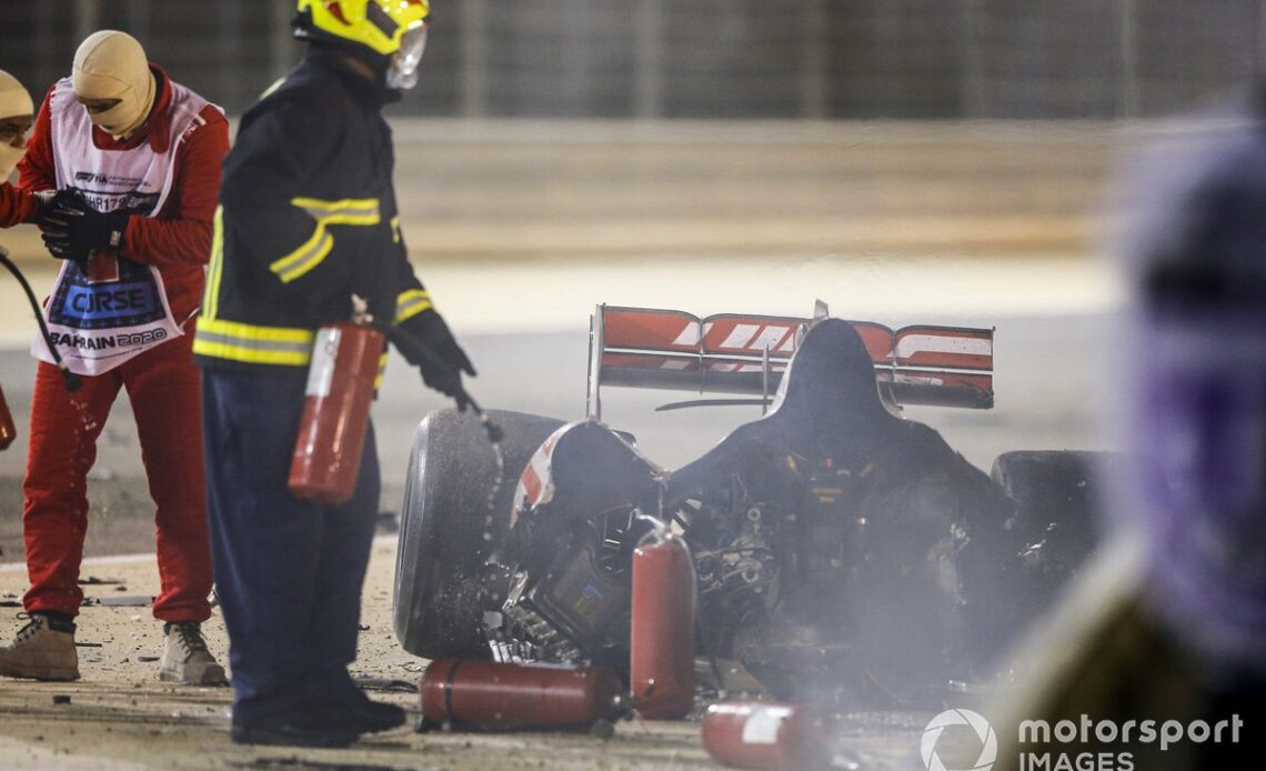Marshals deal with the wreckage after a huge crash for Romain Grosjean, Haas VF-20, on the opening lap