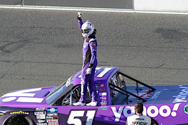 Kyle Busch celebrates on the side of his No. 51 purple Yahoo! Truck after winning at Sonoma, NKP