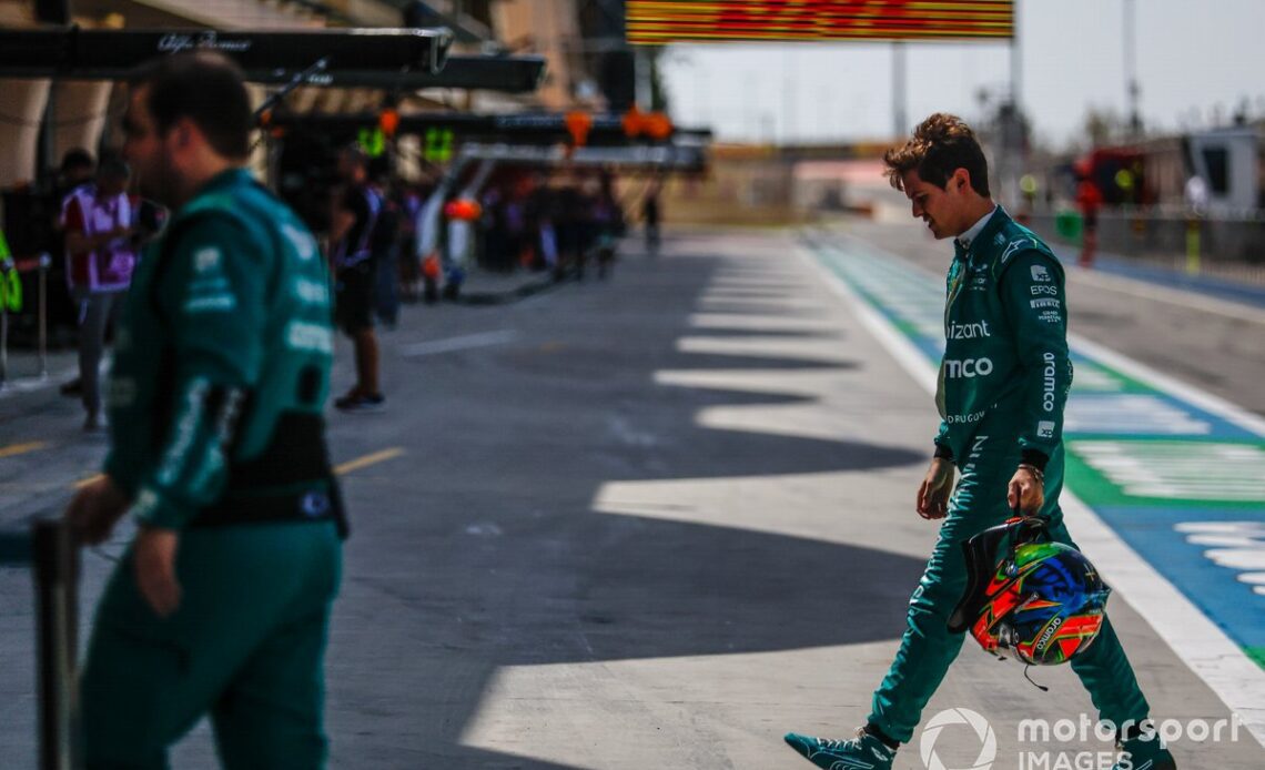 Felipe Drugovich, Aston Martin F1 Team, walks back to the garage after his car stopped on track at the Bahrain test