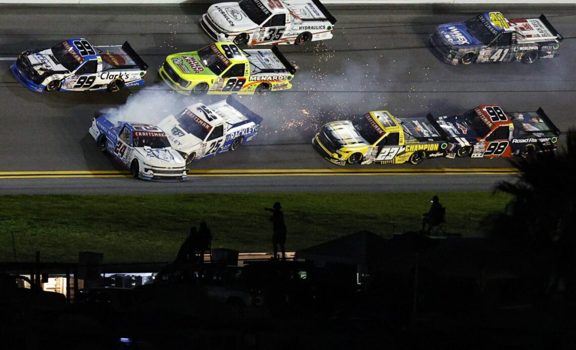 Rajah Caruth, driver of the #24 Wendell Scott Foundation Chevrolet, and Matt DiBenedetto, driver of the #25 Rackley Roofing Chevrolet, spins after an on-track incident during the NASCAR Craftsman Truck Series NextEra Energy 250 at Daytona International Speedway on February 17, 2023 in Daytona Beach, Florida. (Photo by Sean Gardner/Getty Images)