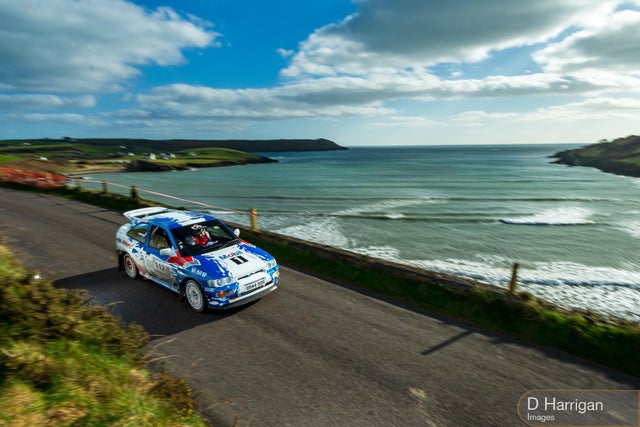 A Group A Escort Cosworth rallying through the Irish landscape.