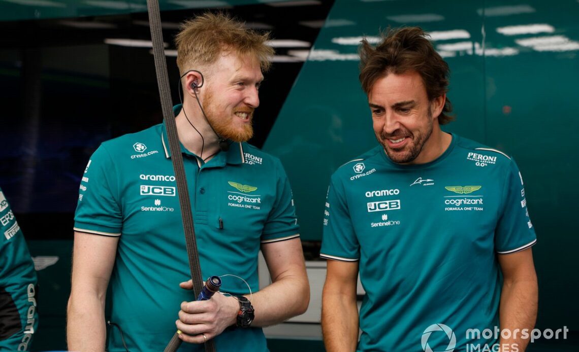 Fernando Alonso, Aston Martin F1 Team, with a team member in the garage