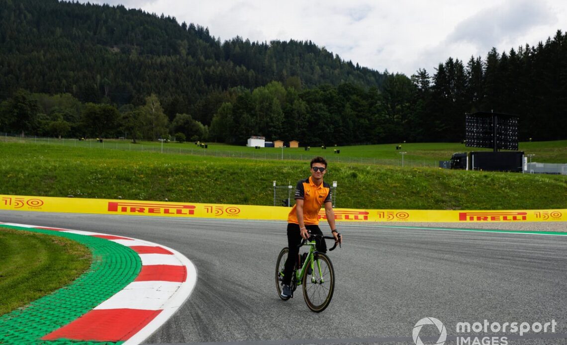 Lando Norris, McLaren, cycles the track