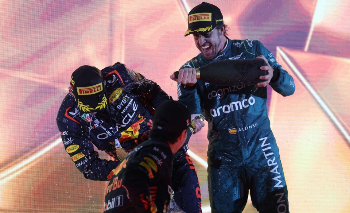 Race winner Max Verstappen of the Netherlands and Oracle Red Bull Racing, Second placed Sergio Perez of Mexico and Oracle Red Bull Racing and Third placed Fernando Alonso of Spain and Aston Martin F1 Team celebrate on the podium during the F1 Grand Prix of Bahrain at Bahrain International Circuit on March 05, 2023 in Bahrain, Bahrain. (Photo by Lars Baron/Getty Images)
