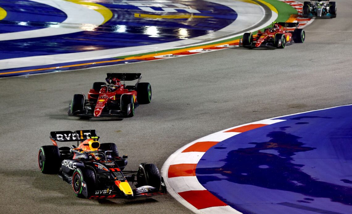 Sergio Perez of Mexico driving the (11) Oracle Red Bull Racing RB18 leads Charles Leclerc of Monaco driving the (16) Ferrari F1-75 during the F1 Grand Prix of Singapore at Marina Bay Street Circuit on October 02, 2022 in Singapore, Singapore. (Photo by Mark Thompson/Getty Images,)
