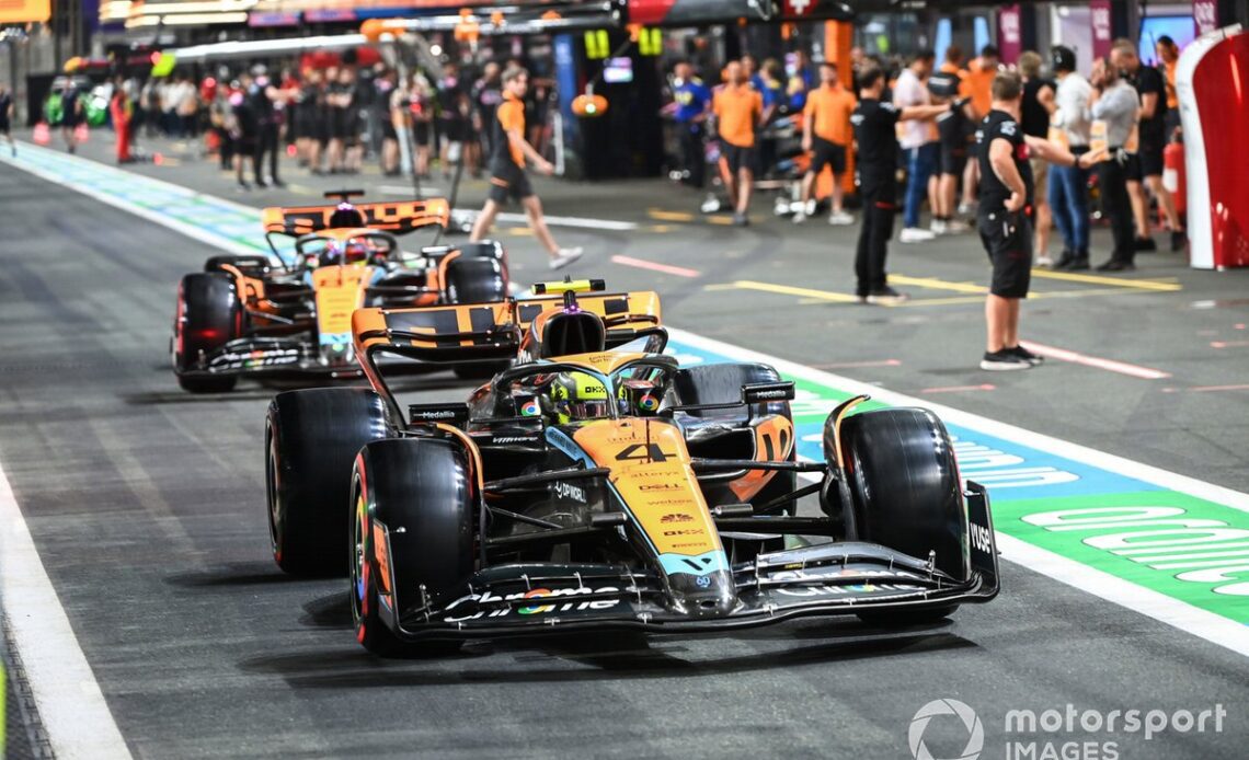 Lando Norris, McLaren MCL60, Oscar Piastri, McLaren MCL60, in the pit lane