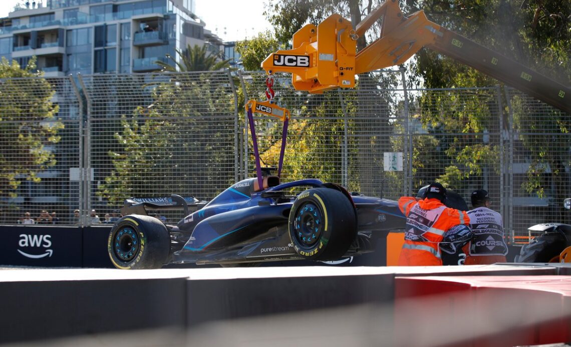 Marshals remove the damaged car of Alex Albon, Williams FW45, from the circuit