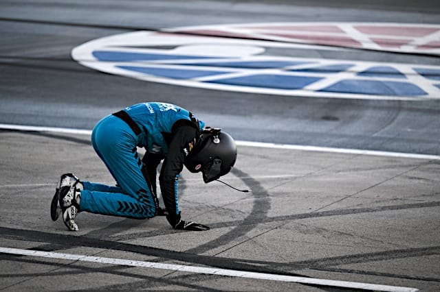 NASCAR CRAFTSMAN Truck Series Carson Hocevar kneels on the ground, NKP