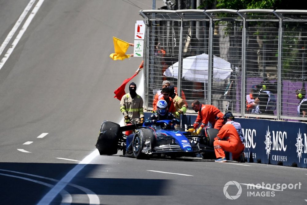 Logan Sargeant, Williams FW45, is assisted by marshals after crashing out of the Sprint Shootout