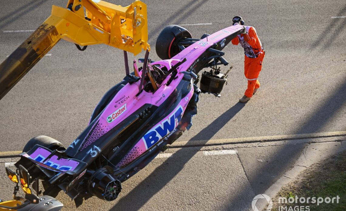 Marshals remove the damaged car of Esteban Ocon, Alpine A523, from the circuit after the race