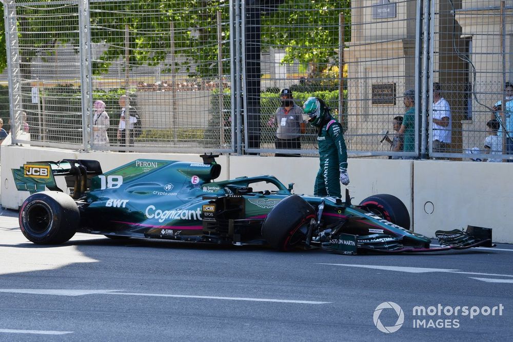 Lance Stroll, Aston Martin AMR21, walks away from his car after hitting the wall