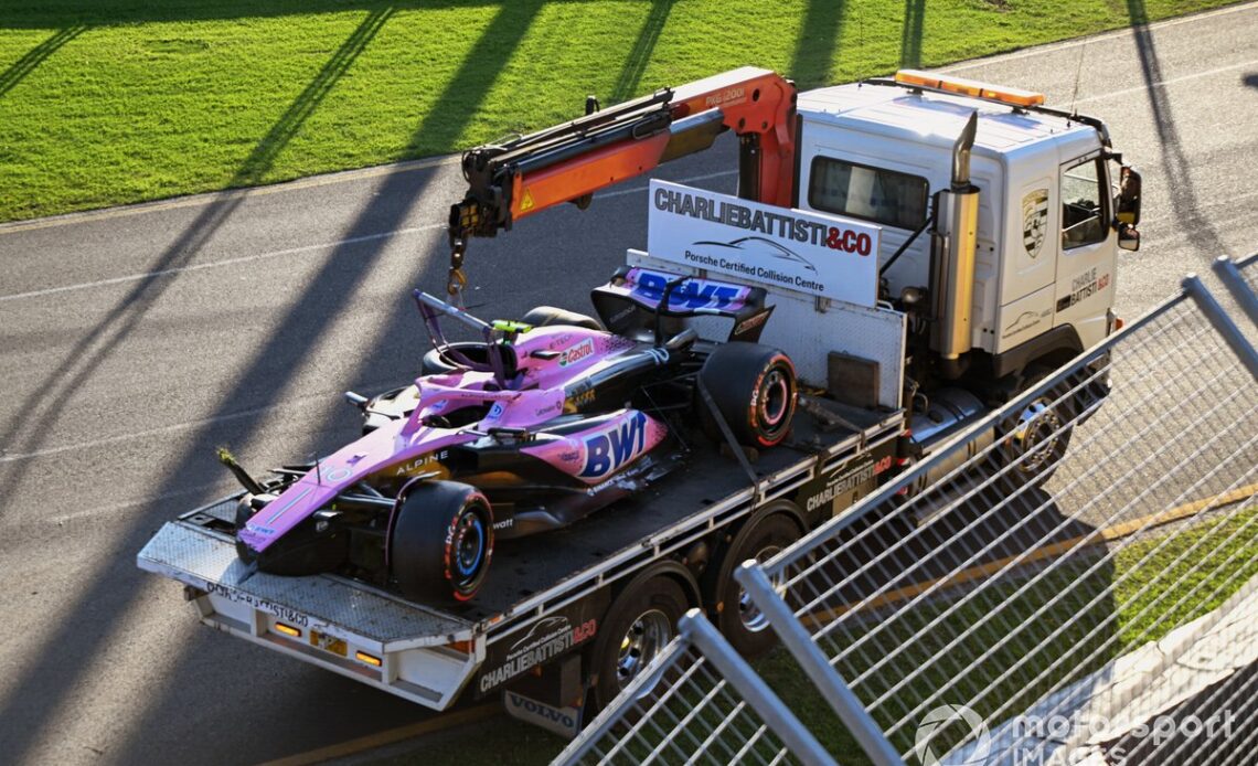 Marshals remove the damaged car of Pierre Gasly, Alpine A523, with a truck after the race