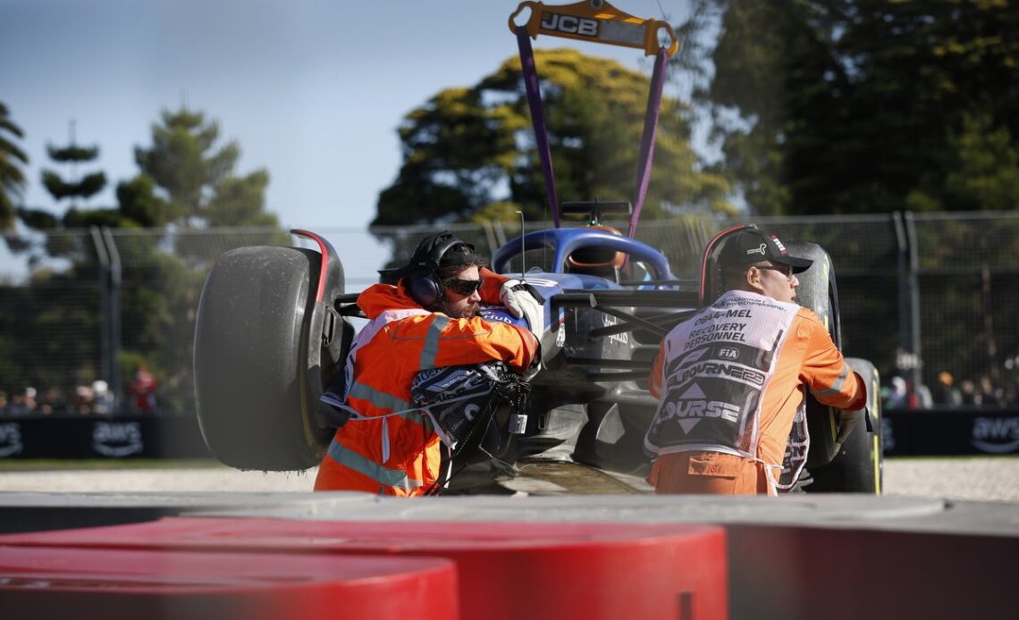 Marshals remove the damaged car of Alex Albon, Williams FW45, from the circuit