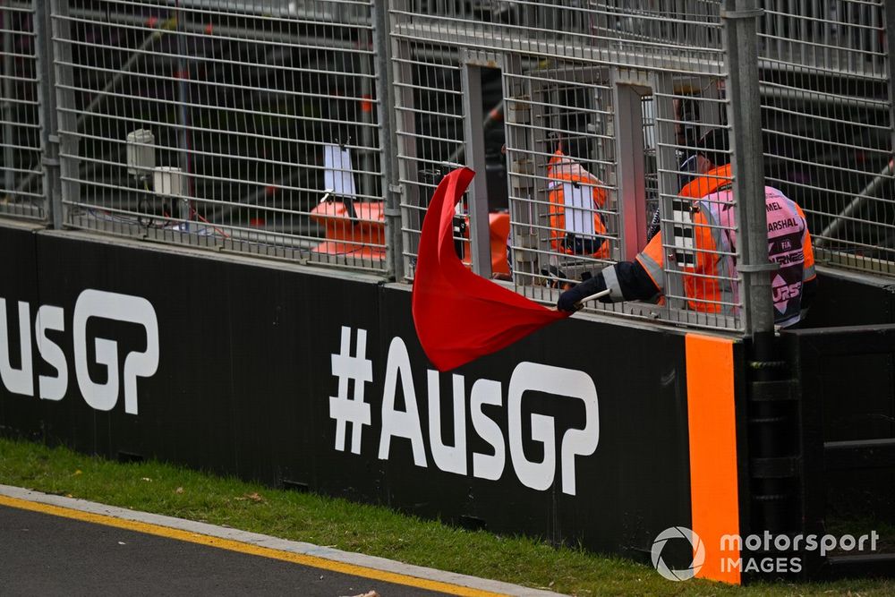 A marshal waves a red flag