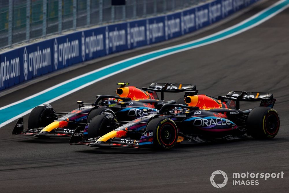 Max Verstappen, Red Bull Racing RB19, passes Sergio Perez, Red Bull Racing RB19, for the lead