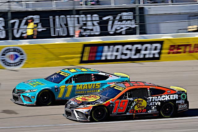 2023 Cup Las Vegas II side-by-side racing II - Joe Gibbs Racing teammates Denny Hamlin, No. 11 Toyota, and Martin Truex Jr., No. 19 Toyota (Credit: NKP)