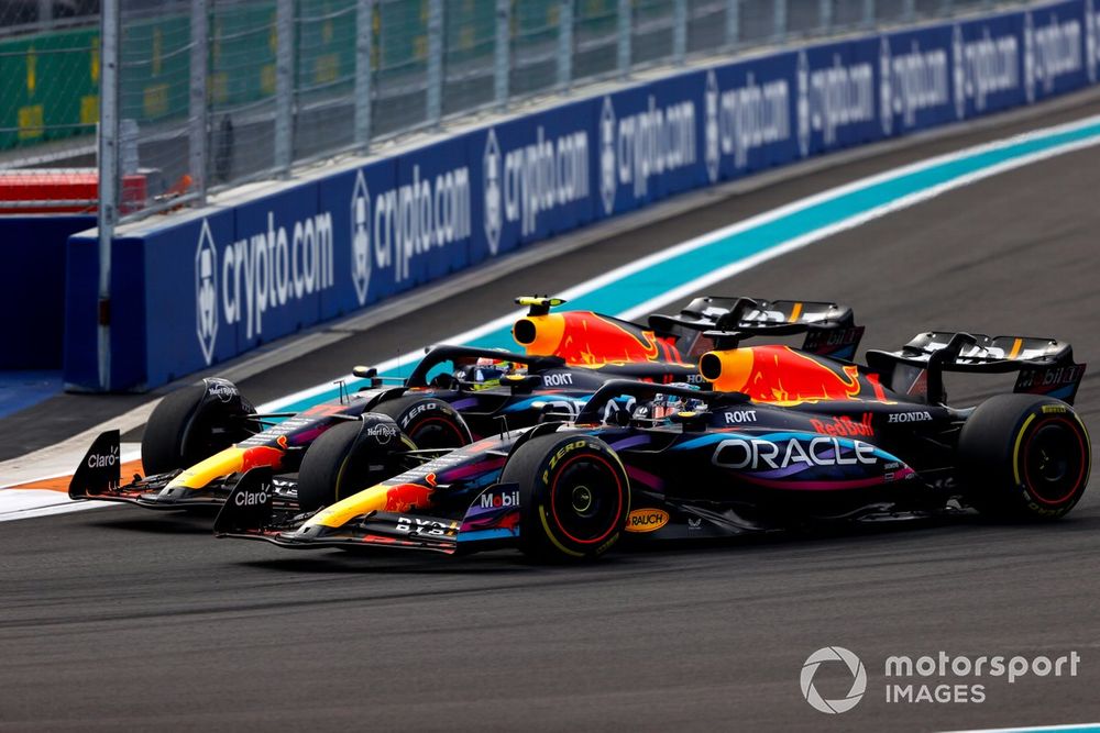 Max Verstappen, Red Bull Racing RB19, passes Sergio Perez, Red Bull Racing RB19, for the lead