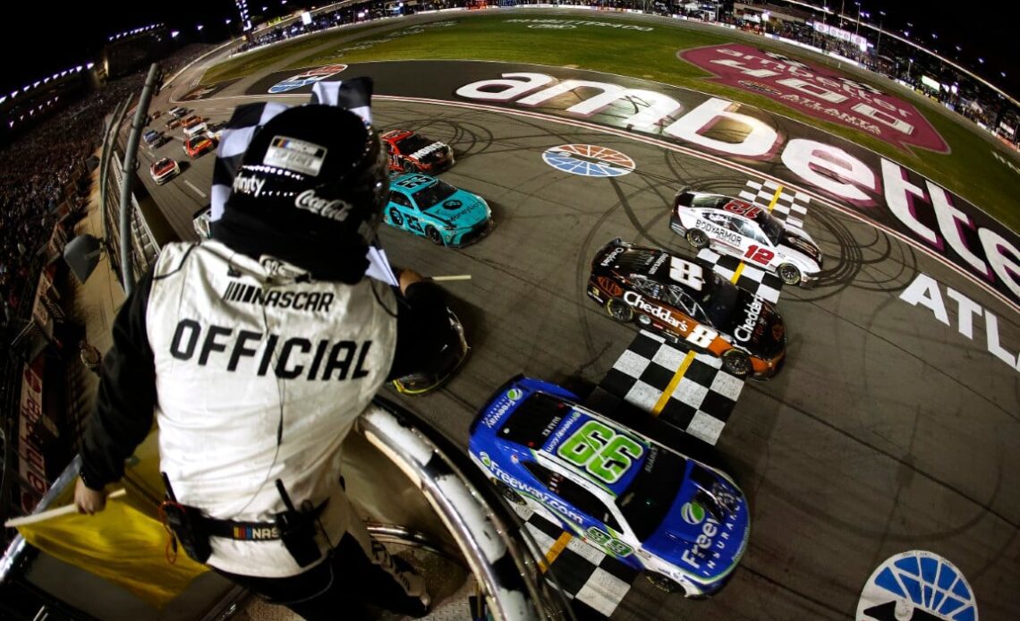 Daniel Suarez, driver of the #99 Freeway Insurance Chevrolet, crosses the finish line ahead of Kyle Busch, driver of the #8 Cheddar's Scratch Kitchen Chevrolet, and Ryan Blaney, driver of the #12 BodyArmor Zero Sugar Ford, to win the NASCAR Cup Series Ambetter Health 400 at Atlanta Motor Speedway on February 25, 2024 in Hampton, Georgia. (Photo by Alex Slitz/Getty Images)