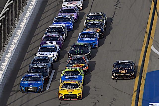 Joey Logano heads the middle lane as the field goes by Kyle Busch running on the bottom, Chris Buescher on the top lane in 2023 Daytona 500; NKP