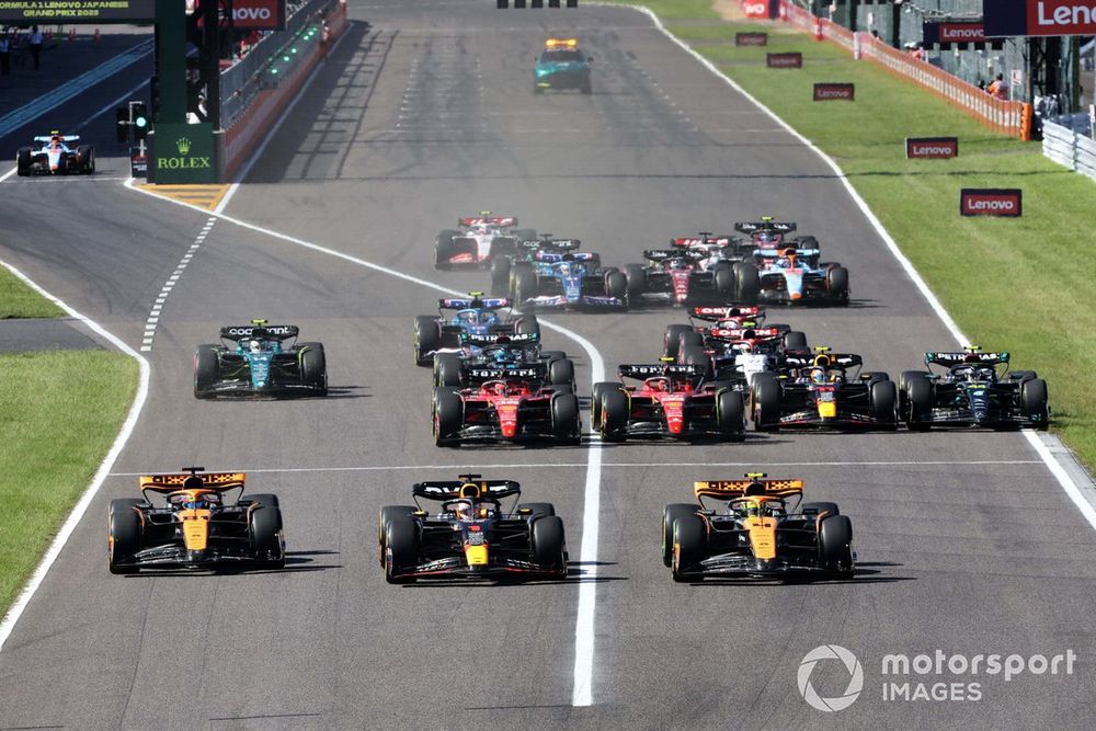 Max Verstappen, Red Bull Racing RB19, leads Lando Norris and Oscar Piastri, McLaren MCL60s, at the start of the 2023 Japanese GP