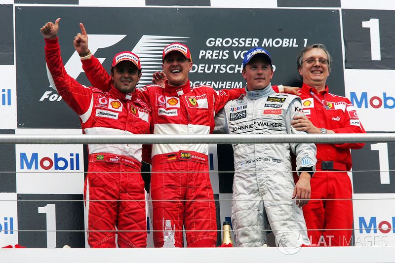 The podium: Felipe Massa, Ferrari, second; Michael Schumacher, Ferrari, race winner; Kimi Raikkonen, McLaren, third; Paolo Martinelli, Ferrari Engine Director