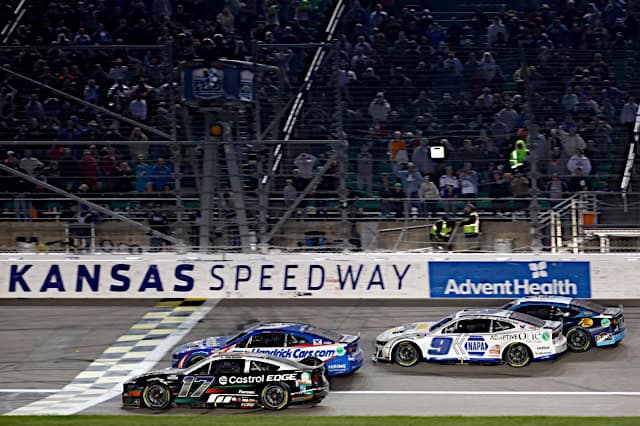 Nascar Cup Series cars of Chris Buescher and Kyle Larson racing to the finish line, NKP