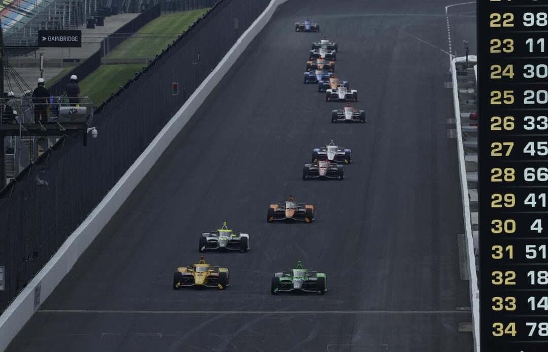 Several cars go down the main straight in practice ahead of the 2024 Indianapolis 500