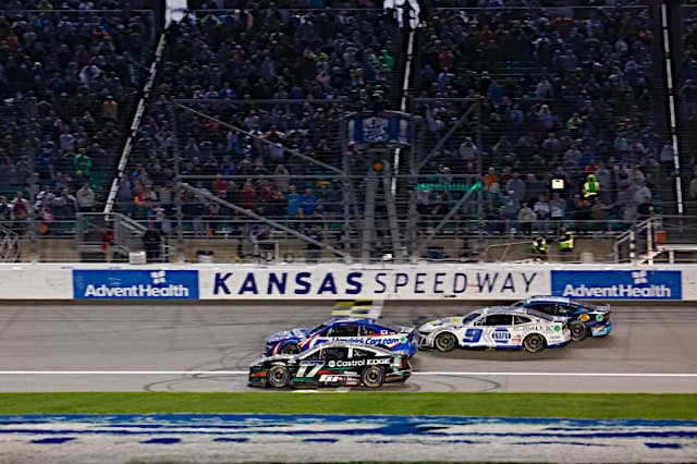 Nascar Cup Series cars of Kyle Larson and Chris Buescher racing at checkered flag at Kansas, NKP