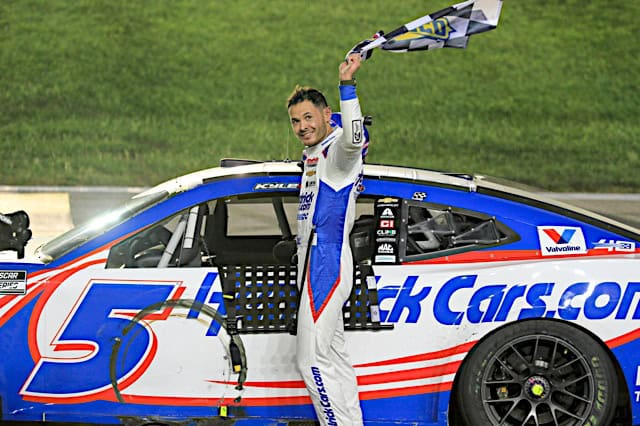 Nascar Cup Series driver Kyle Larson celebrates with checkered flag after winning at Kansas Speedway, NKP
