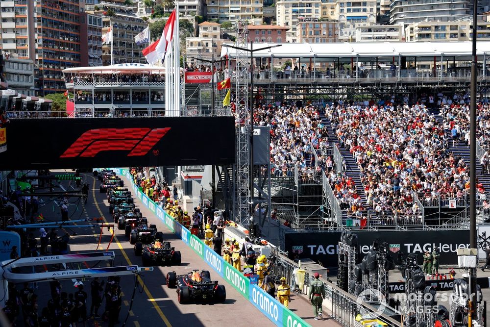 Sergio Perez, Red Bull Racing RB20, Max Verstappen, Red Bull Racing RB20, in the queue to leave the pits