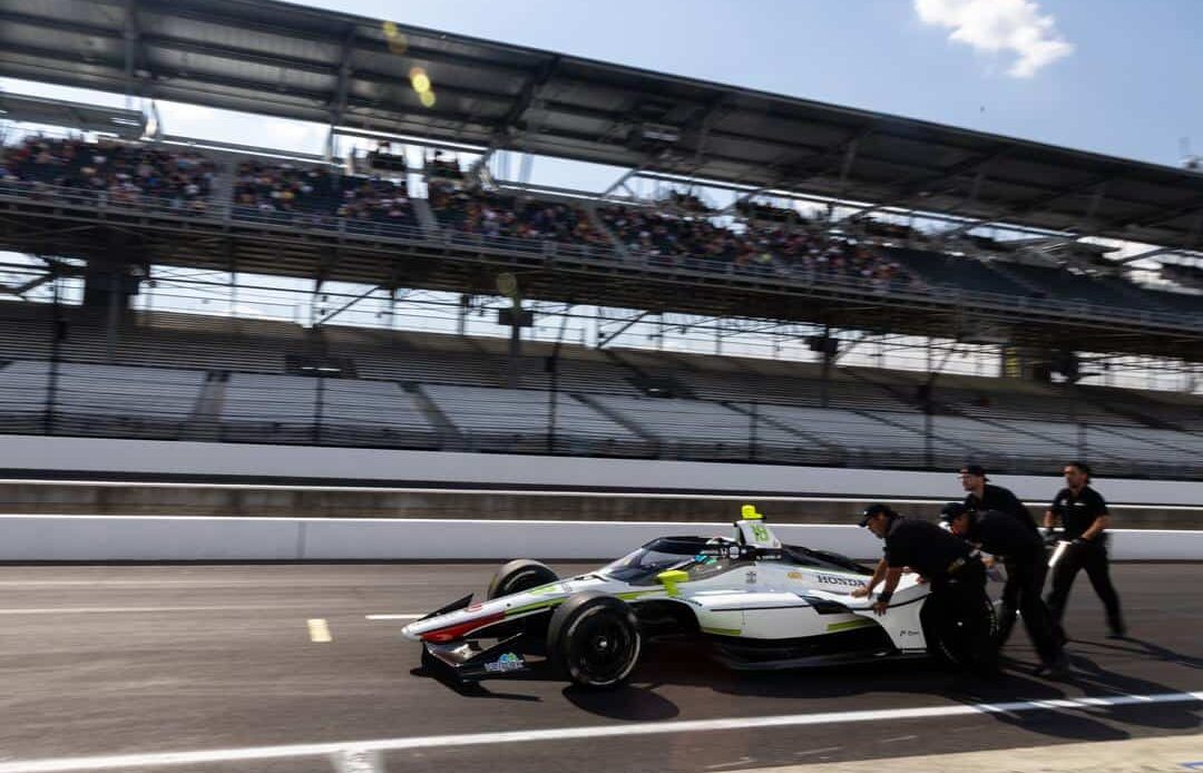 Dale Coyne Racing crew members push Nolan Siegel to the qualifying line during the Last Chance Qualifying session.