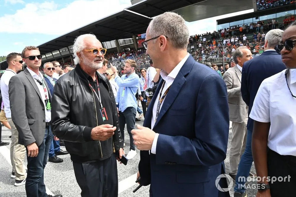 Flavio Briatore and Stefano Domenicali, CEO, Formula 1, on the grid