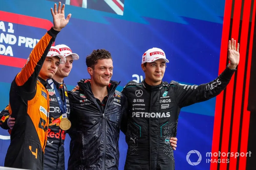 Lando Norris, McLaren F1 Team, 2nd position, Max Verstappen, Red Bull Racing, 1st position, the Red Bull trophy delegate and George Russell, Mercedes-AMG F1 Team, 3rd position, on the podium