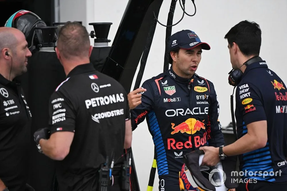 Sergio Perez, Red Bull Racing, with his performance coach Jose Canales in the pit lane