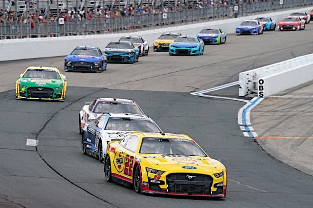 Joey Logano leads a pack of NASCAR racecars at New Hampshire Motor Speedway, July 2022. Photo: NKP