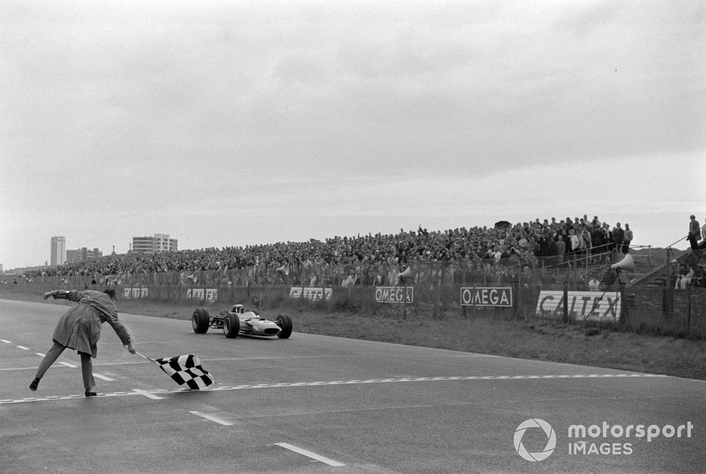 Jackie Stewart, Matra MS10 Ford, takes the chequered flag for victory.