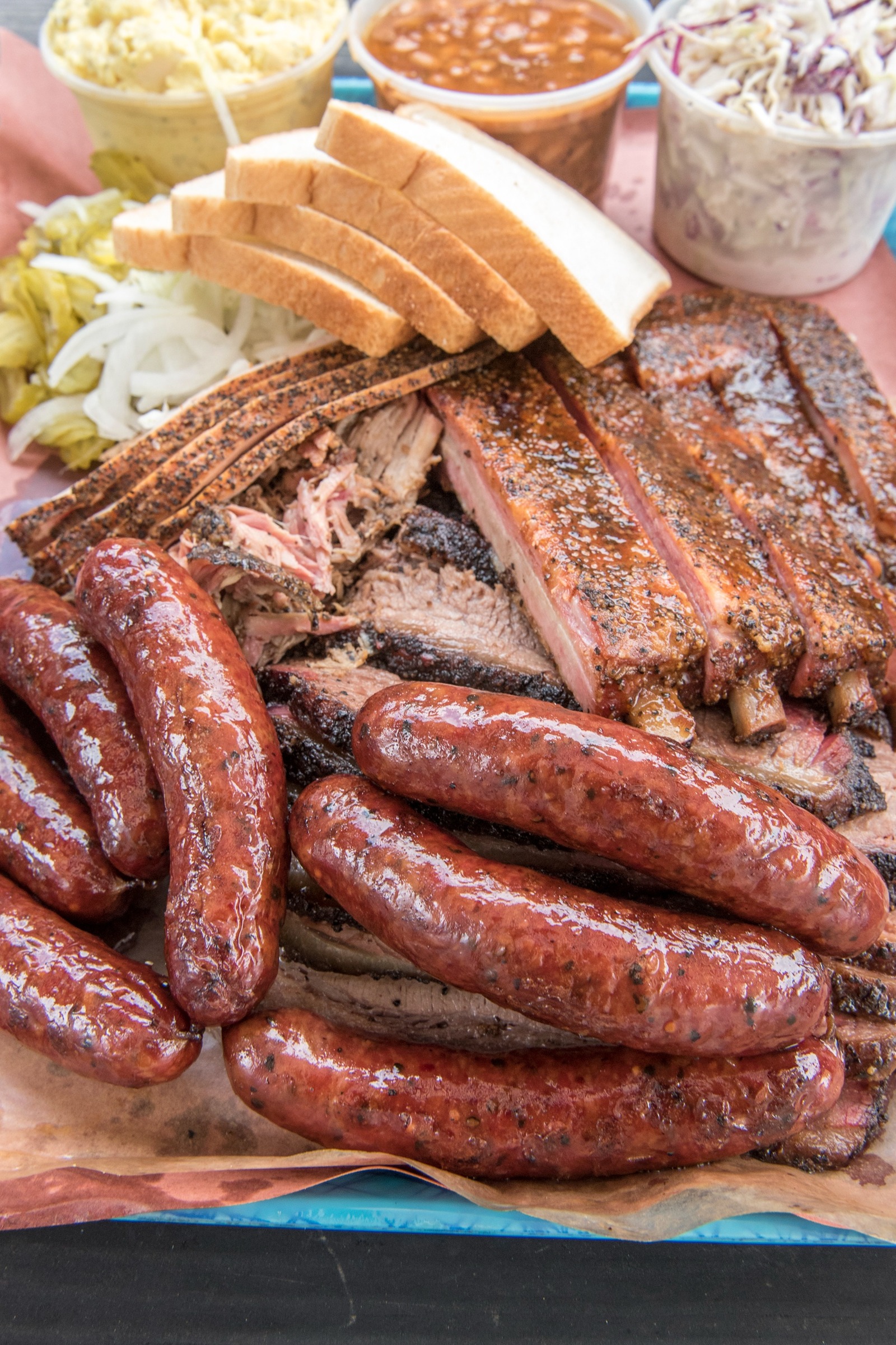 A full spread of Franklin Barbecue meats and sides.