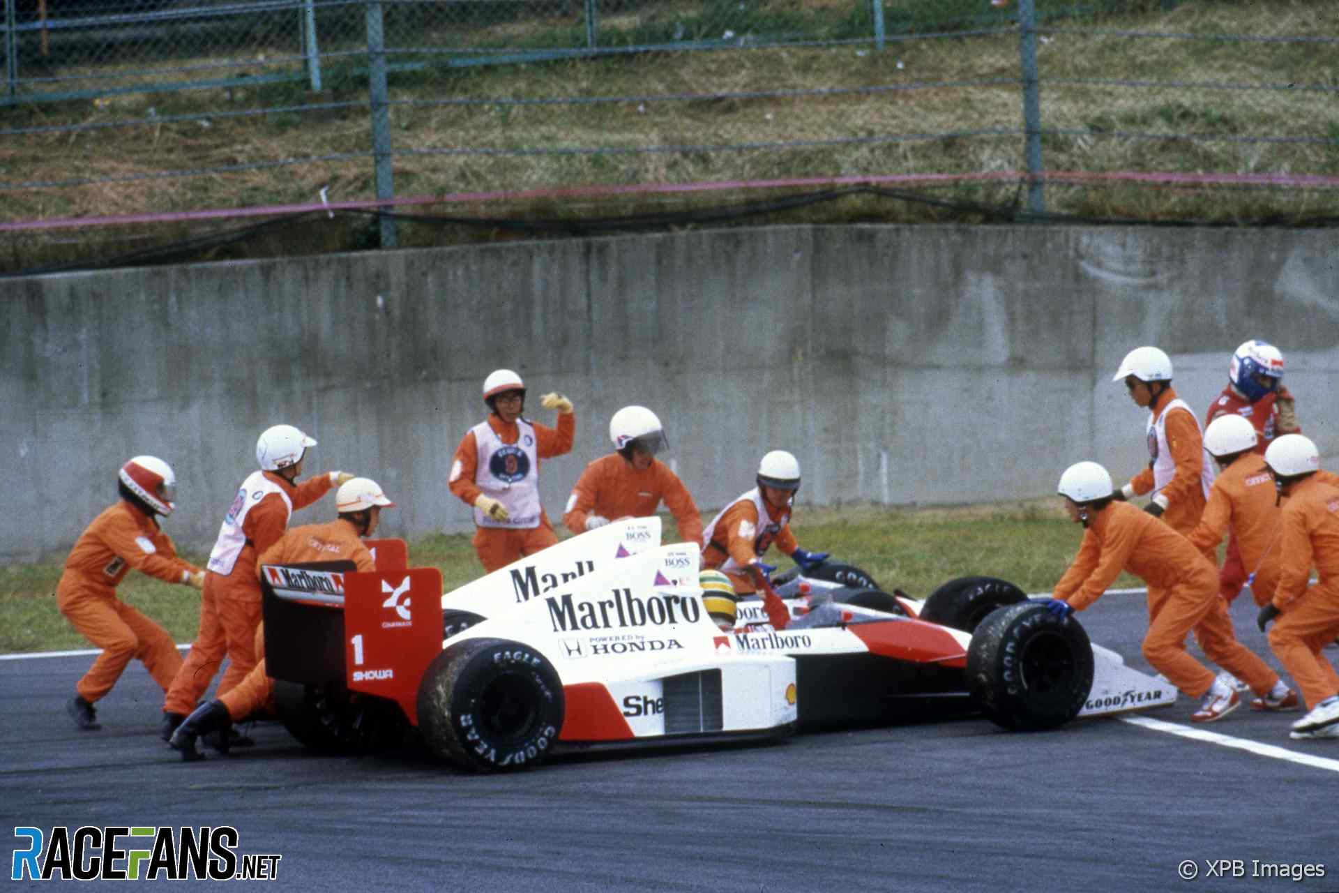 Alain Prost and Ayrton Senna collide while fighting for the lead of the 1989 Japanese Grand Prix