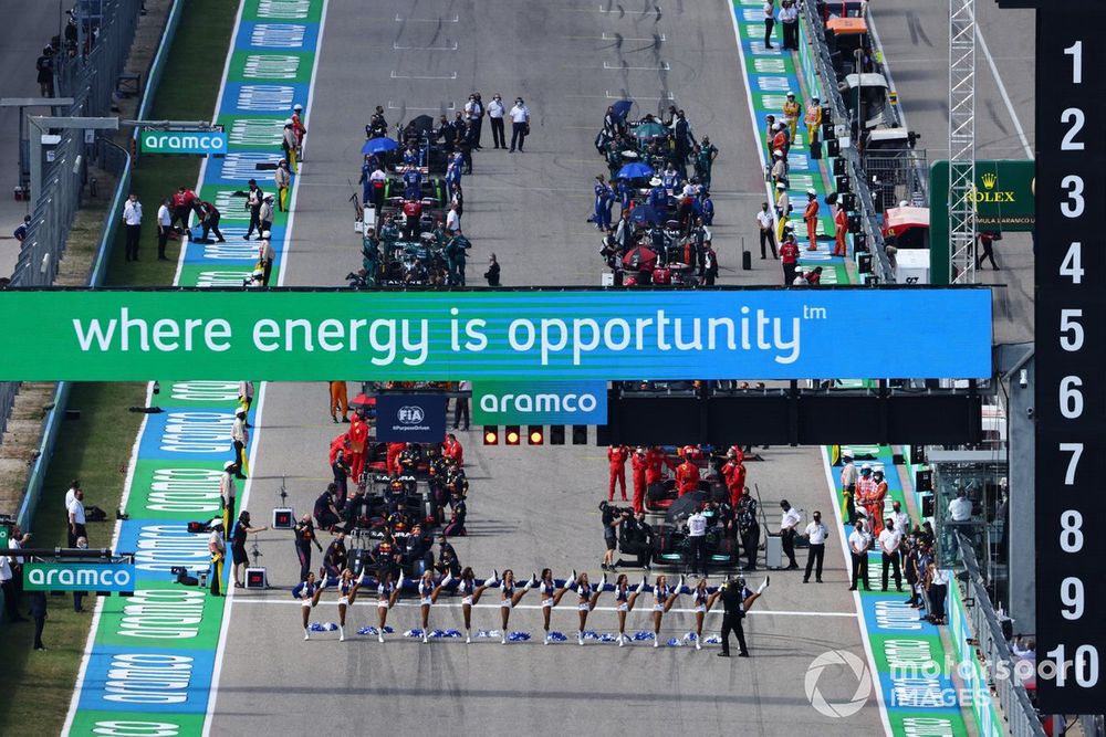 The Dallas Cowboys Cheerleaders perform at the front of the grid prior to the start of the US Grand Prix