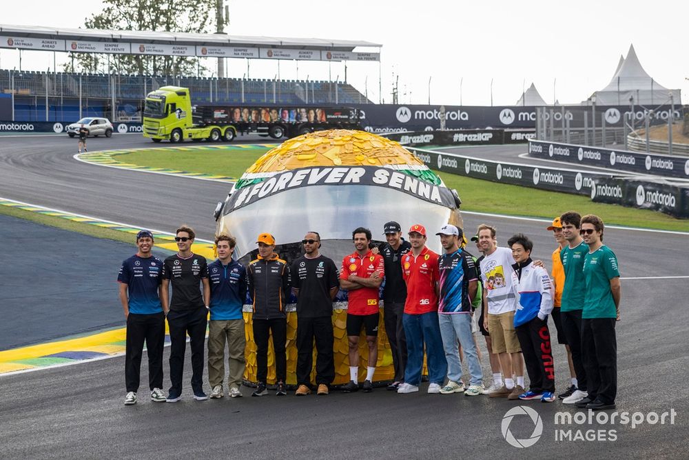 The drivers line up on the track for a photo shoot with a tribute to Ayrton Senna